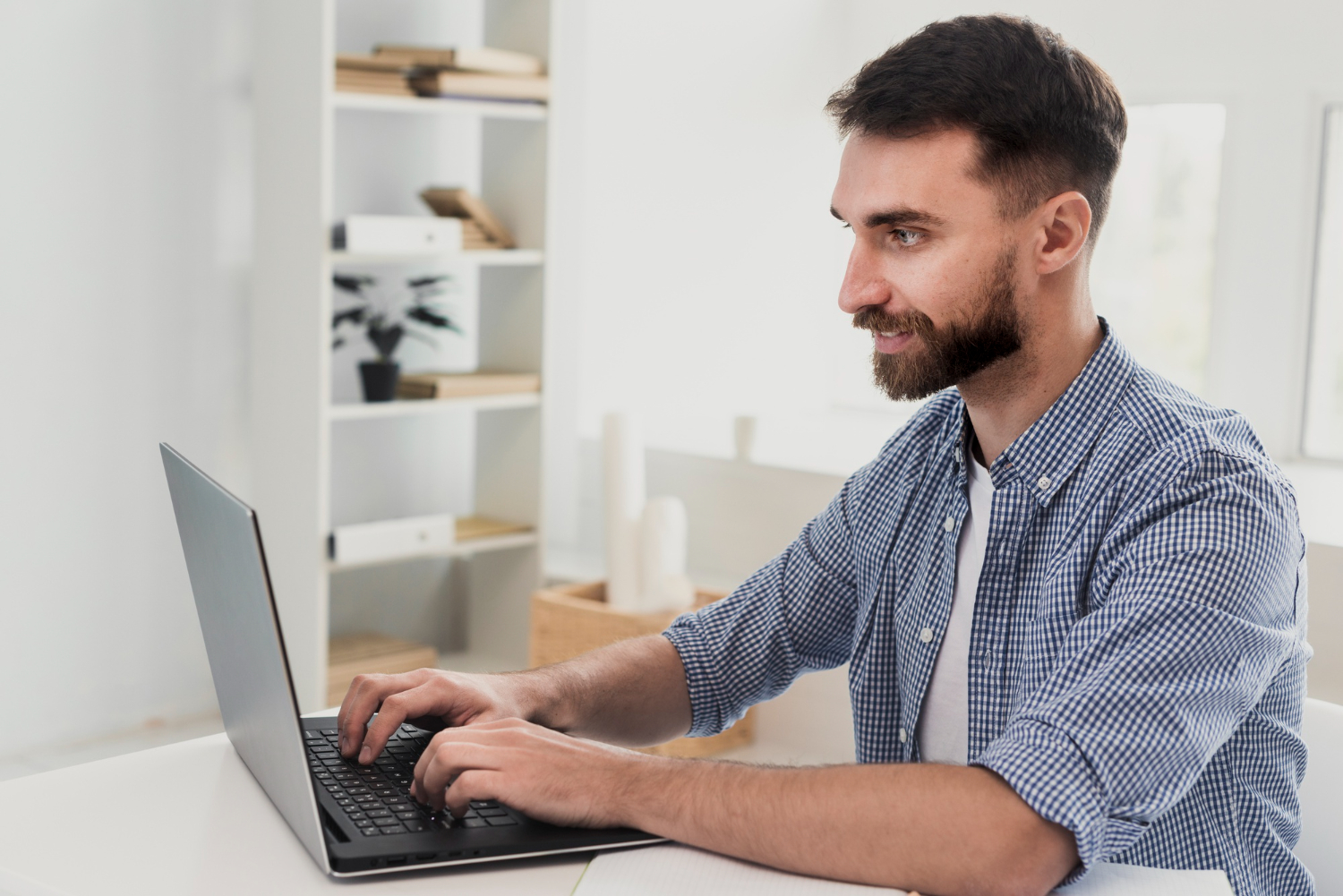 jovem adulto sentado em frente a um notebook